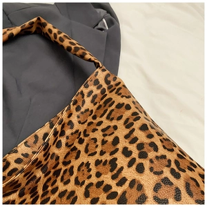 Detail of the leopard print canvas texture and seamless strap stitching on this tote bag
