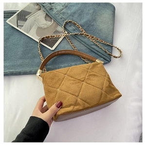 Detail of caramel quilted crossbody bag with gold chain and matte suede texture
