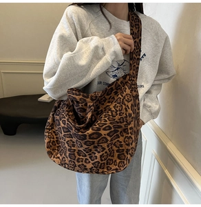 Close-up of leopard print tote bag with soft texture and wide matching shoulder strap
