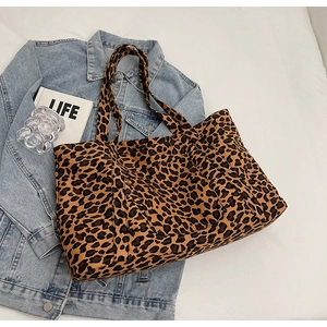 Detail of spacious leopard print tote bag in durable canvas laid on denim fabric