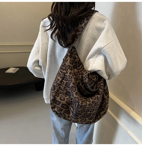 Macro detail of the leopard print canvas tote bag with wide shoulder strap