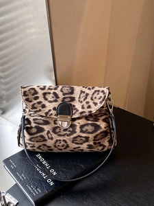 Classic leopard print crossbody bag with black leather strap and silver metal buckle