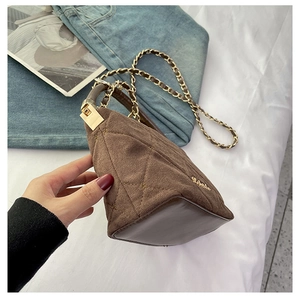 Detail of brown suede quilted bag with gold star rivets and elegant chain strap