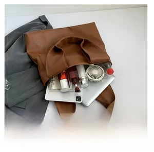Top view of large brown pebble leather tote showing spacious capacity for tablet and items