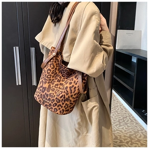 Leopard print bucket bag detail worn with a beige trench coat for a stylish daily look