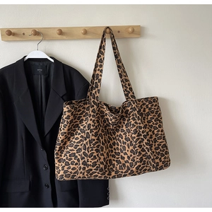 Close-up of leopard print canvas tote bag showing thick durable fabric and wide shoulder strap