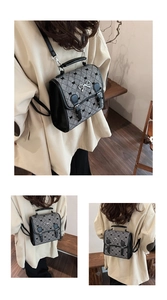 Detail view of mini retro backpack showing gray plaid fabric and black leather trim accents