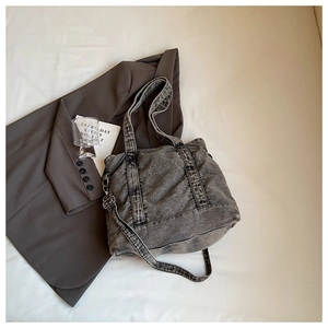 Close-up of gray washed denim tote bag showing vintage texture and large interior space