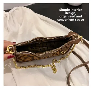Detail view of leopard print handbag interior featuring organized space and zipper pocket