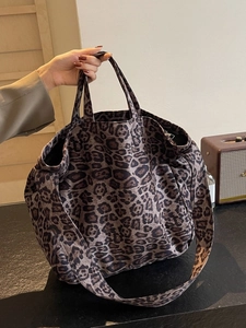 Large leopard print tote bag with wide shoulder strap for travel and daily commute use