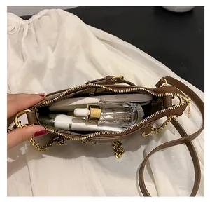 Internal view of brown leather bag showing spacious storage for makeup and phone