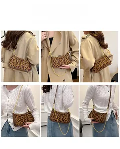 Detail showing leopard print handbag with detachable gold chain and brown leather strap