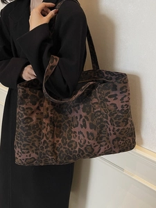 Large leopard print canvas tote bag with shoulder straps for women on plain background