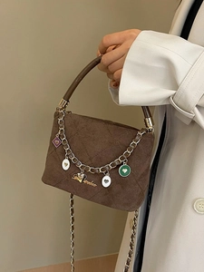 Elegant brown quilted suede handbag with vintage gold chain strap and heart charms