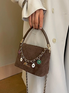 Elegant brown quilted crossbody bag with colorful heart charms and matte leather finish