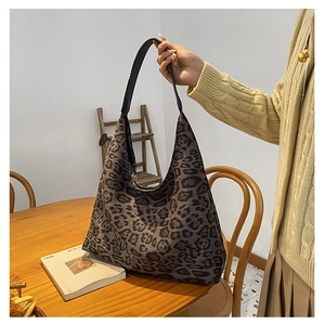 Detailed view of the large leopard print hobo tote bag with a durable canvas texture