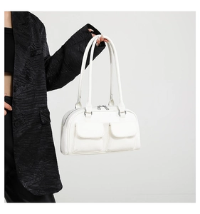 Detailed texture of white minimalist faux leather handbag with symmetrical front pockets