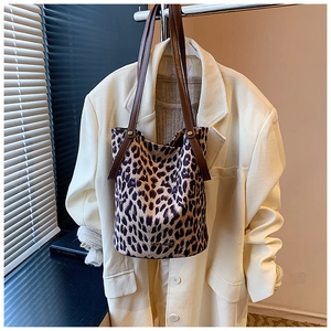 Leopard print bucket bag detail hanging with stylish brown straps and metallic logo