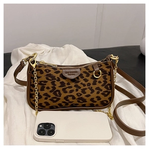 Macro shot of leopard print handbag with golden chain and phone for size reference