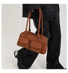 Detailed view of brown lychee grain leather underarm bag with double front flap pockets