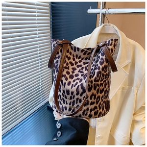 Detail of leopard print bucket bag featuring premium suede texture and sturdy leather strap