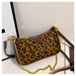 Detail of leopard print suede crossbody bag with gold chain and leather shoulder strap