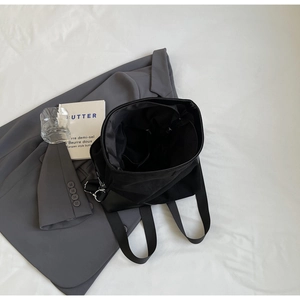 Top view of spacious black canvas tote bag featuring internal zipper pocket and side slots
