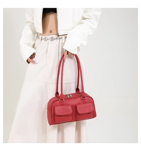 Detailed view of a red lychee pattern shoulder bag with two front flap pockets and silver hardware