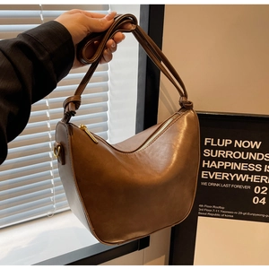Detail of matte brown PU leather hobo bag featuring a decorative knotted shoulder strap