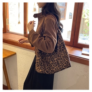 Detail of a vintage leopard print tote bag in soft velvet fabric shown in a lifestyle setting