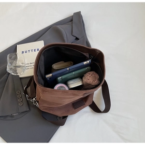 Top view of large brown tote bag interior showing spacious capacity for tablets and essentials