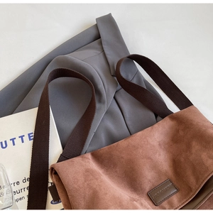 Top-down view of brown matte tote bag with wide strap and minimalist brand label
