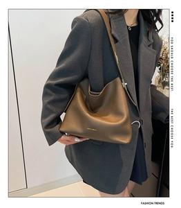 Brown leather large capacity hobo bag styled with a grey blazer for a modern office look