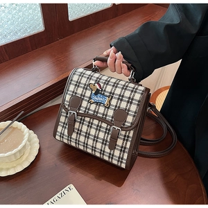 Detail of vintage plaid bag with puppy embroidery and adjustable leather strap