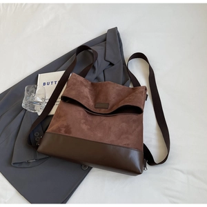 Detail of vintage brown suede and leather backpack with flap and nylon shoulder strap