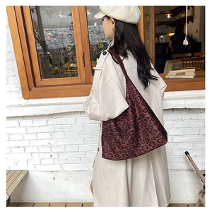 Leopard print tote bag shown on model in street setting with vintage aesthetic