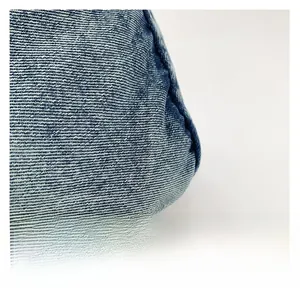 Close-up of blue washed denim fabric showing vintage twill texture for crossbody bag