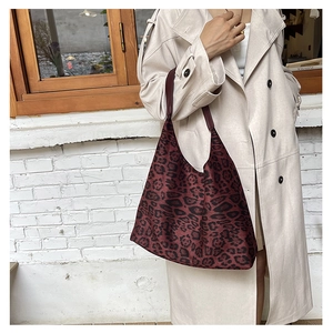Detail of large burgundy leopard print tote bag with soft fabric and wide shoulder strap