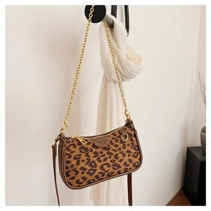 Detailed view of leopard print shoulder bag with gold hardware and removable straps