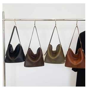 Detail view of large faux leather hobo bags in black, coffee, olive and tan tones