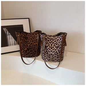 Detailed close-up of leopard print bucket bags with soft suede texture and leather straps