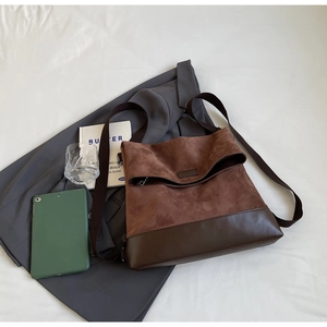 Detailed flat-lay of a brown patchwork tote bag with suede and faux leather textures