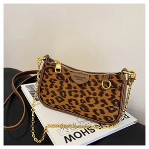 Detail view of leopard print shoulder bag with gold chain and branded leather patch