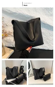 Detail of black pebbled leather tote bag set with matching zippered storage pouch