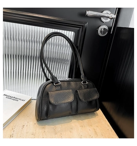 Close-up of black lychee texture leather underarm bag with double front flap pockets