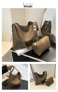 Detail of khaki bucket bag set with litchi texture leather and golden metal clasp