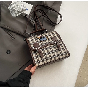 Detail of plaid canvas small bag with dachshund embroidery and brown leather trim