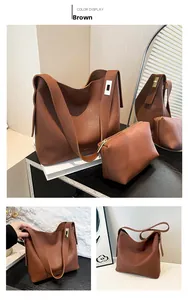 Detail view of brown leather bucket bag set showing the interior pouch and metal clasp