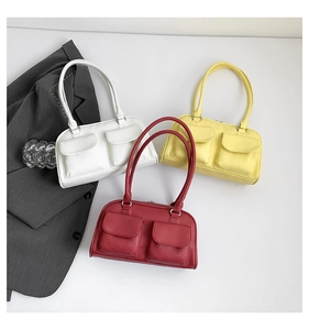 Detailed view of vintage shoulder bags in white, yellow, and burgundy with faux leather texture