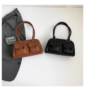 Detailed top view of brown and black leather shoulder bags with symmetrical front pockets